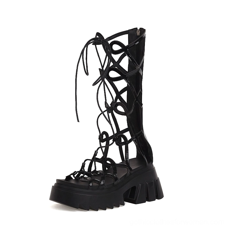 Black patent leather platform sandals front three-quarter view with cutout lace straps