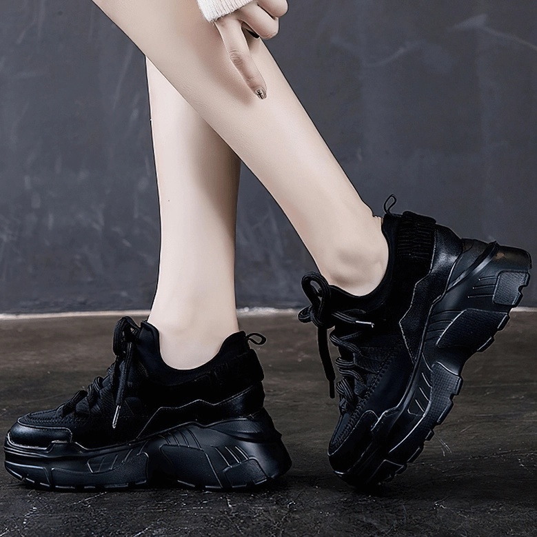 Women's platform sneaker bottom view showing robust lug tread pattern and sole structure
