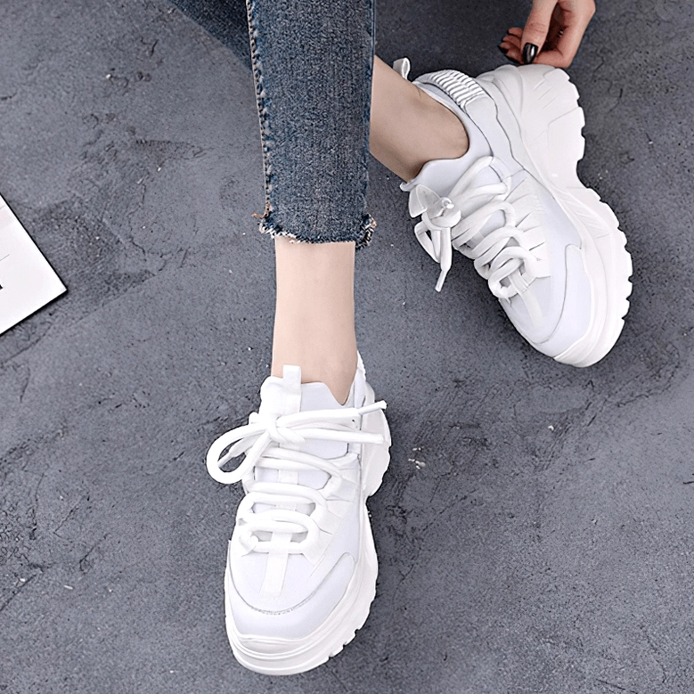 Women's platform sneaker rear view showing heel structure, elevation, and back panel construction
