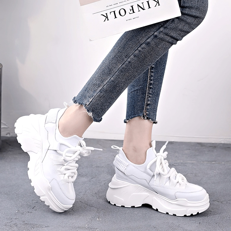 Platform leather sneaker side view emphasizing substantial heel height and sole elevation