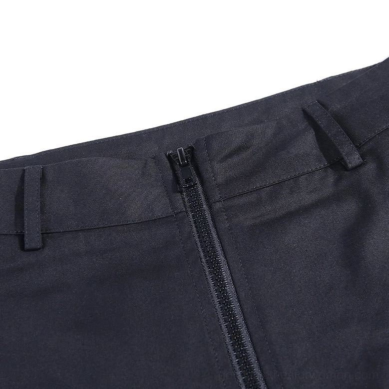 Close-up detail of front zipper and waistband on women's gothic pleated cargo pants with metal hardware