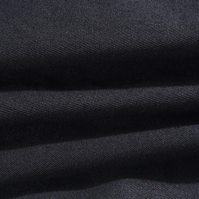 Women's black pleated gothic pants - detail shot showcasing patchwork paneling and industrial design elements