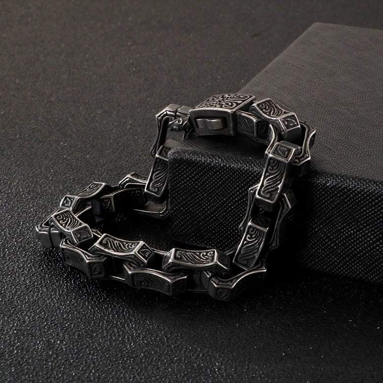Polished silver tone gothic engraved bracelet product photography showing complete link chain design