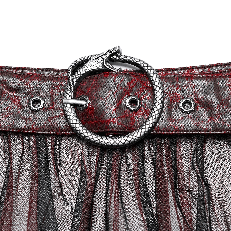 Punk belt close-up detail with snake-shaped metal buckle and rivet decorations on crackled leather