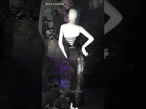 Gothic fishtail mesh skirt on mannequin back view in dark studio setting highlighting lace-up design and industrial aesthetic
