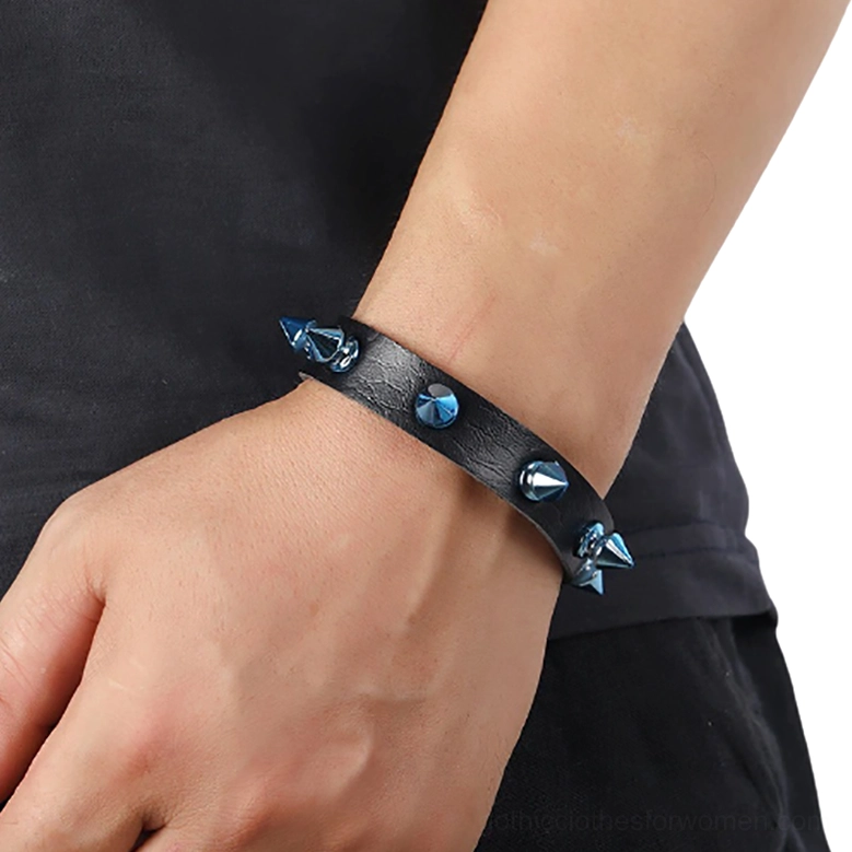 Black leather cuff bracelet with blue cones worn on male wrist close-up gothic style