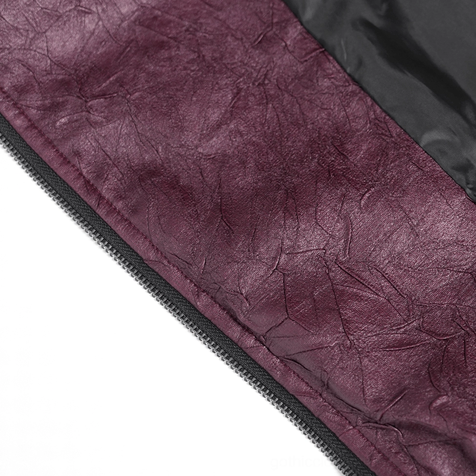 Close-up detail of crinkled dark purple faux leather material with black zipper trim
