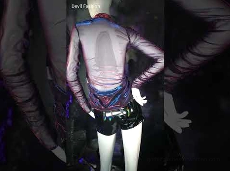 Black background studio photo of purple sheer gothic mesh top showing iridescent fabric and ruched long sleeves