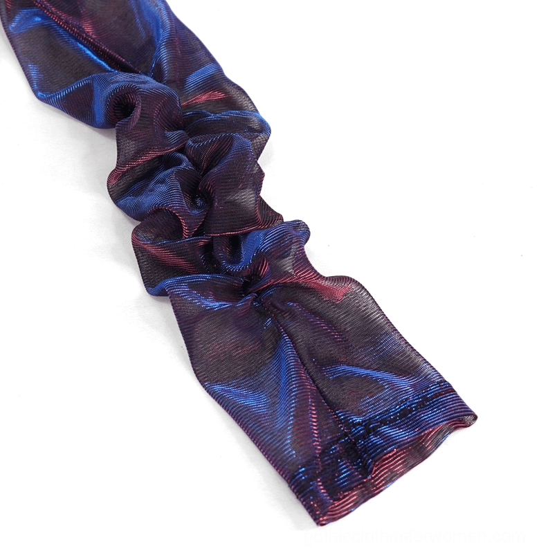 Close-up flat lay of ruched sleeve detail showing iridescent blue-purple shiny gathered mesh fabric