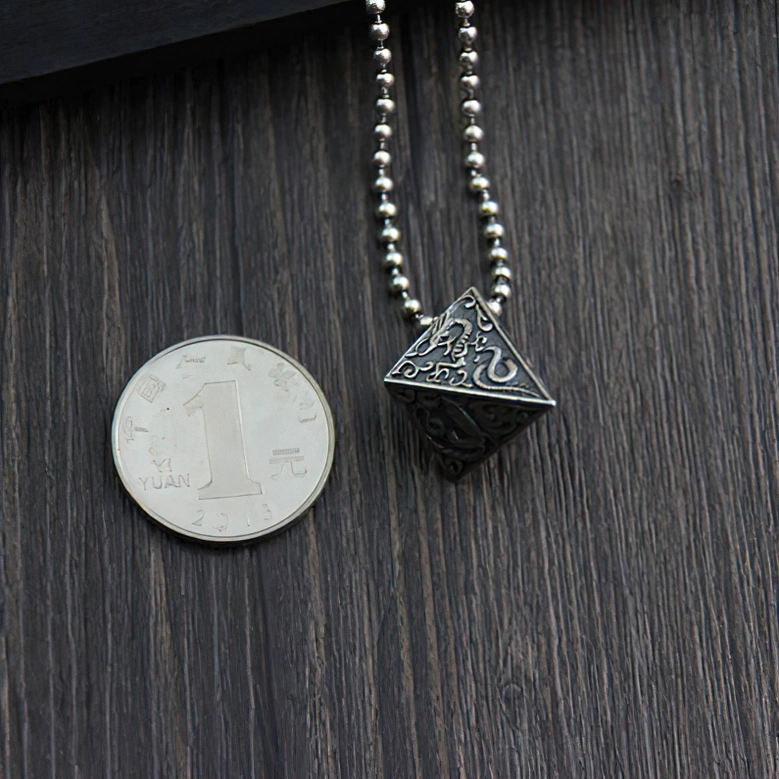 Pyramid silver pendant on beaded chain displayed with one-yuan coin for size reference, top-down view showing scale of gothic necklace pendant