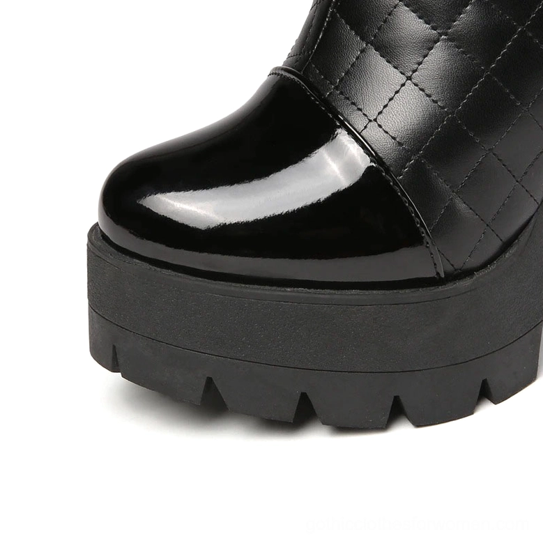 Black quilted gothic boots toe cap and platform sole close-up with patent leather details