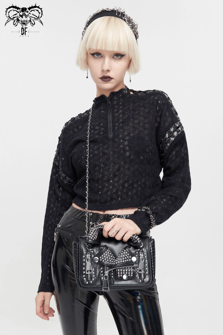 Alternative fashion styling - black quilted cropped top with half-zip collar paired with studded handbag and accessories