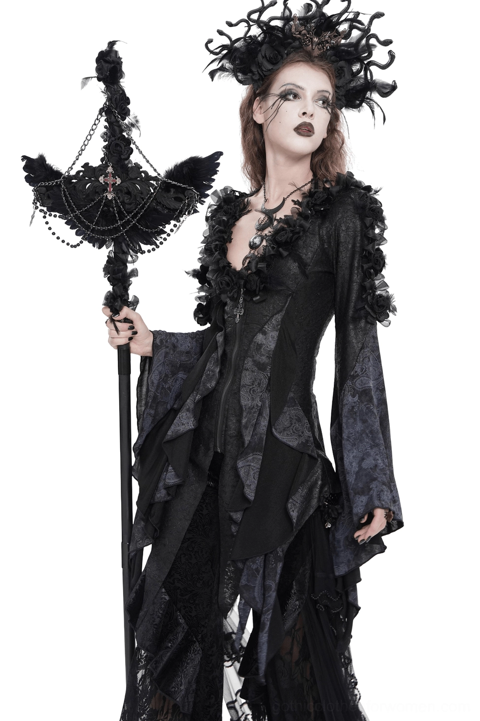 Black raven cross ritual staff with layered chains and rose accents displayed on model wearing asymmetrical gothic dress, right side angle