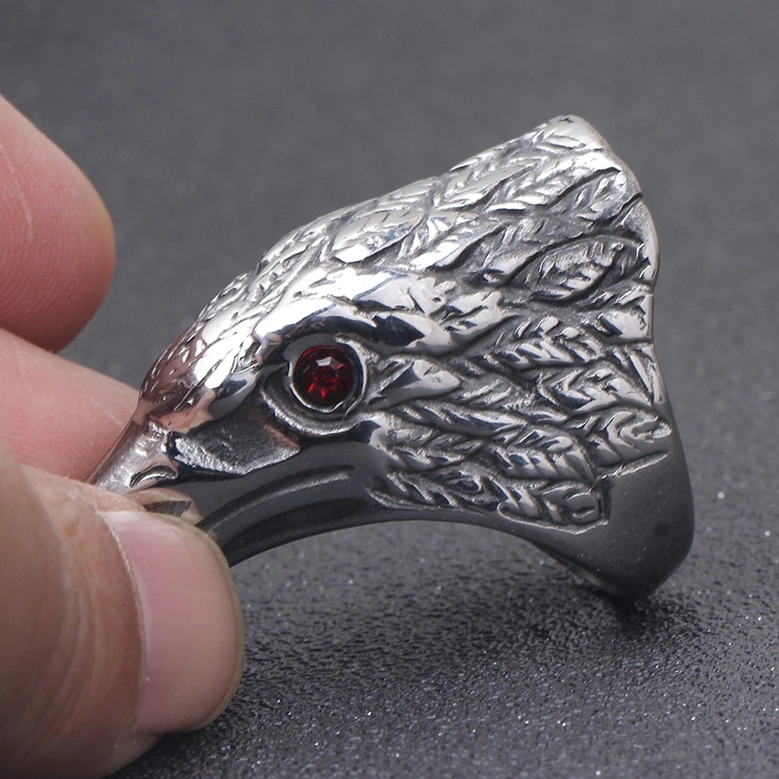 Raven head gothic ring worn on human finger side front view compact design dark background