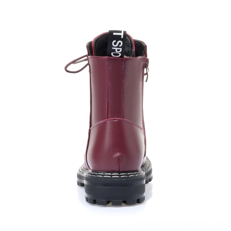 Red leather combat boot lace-up closure system with round toe and square heel silhouette