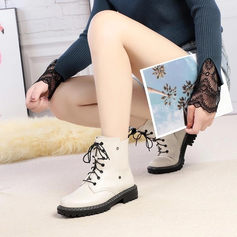 Red leather combat boot worn aesthetic showing how genuine leather develops character