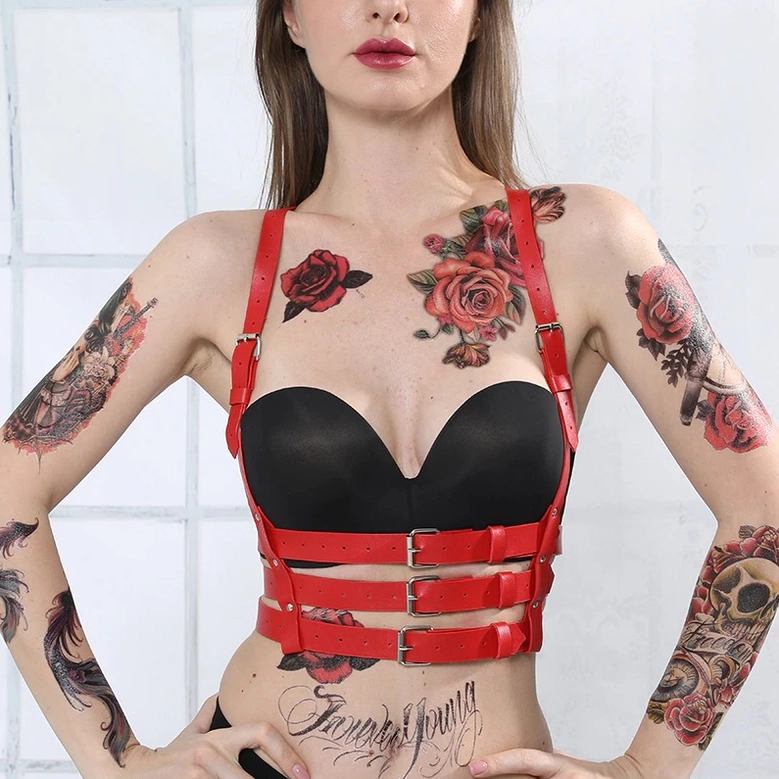 Red gothic PU leather harness close-up detail shot of adjustable buckle system and silver hardware on waist straps