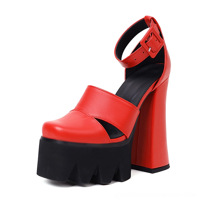Red gothic platform ankle strap heels with bright red leather upper and chunky black serrated platform sole