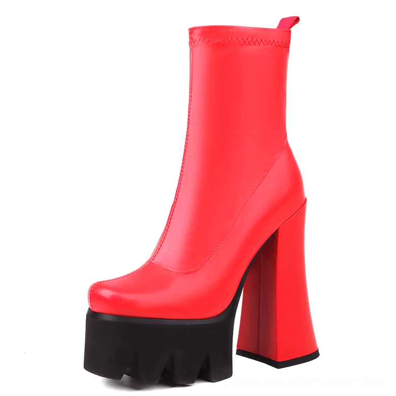 Red genuine leather gothic platform boots with chunky heel and industrial serrated sole, front three-quarter view