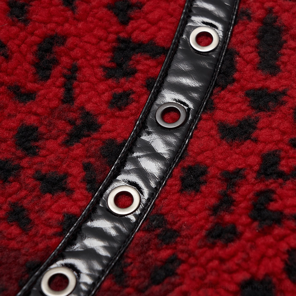 Close-up detail of black PU leather side strap with metal eyelets on red leopard print gothic skirt