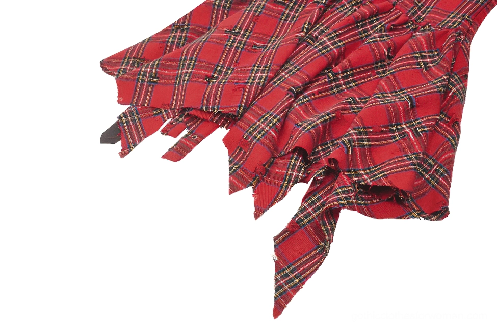 Side close-up view of irregular torn red tartan skirt section with plaid fabric pattern detail