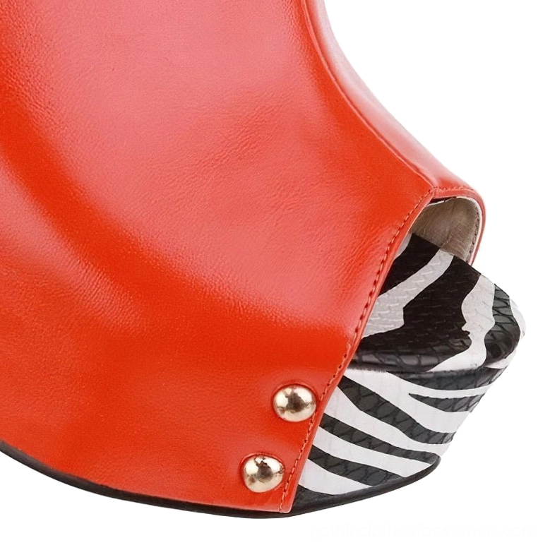 Close-up front view of red zebra stripe wedge sandal showing gold rivet details and peep-toe construction