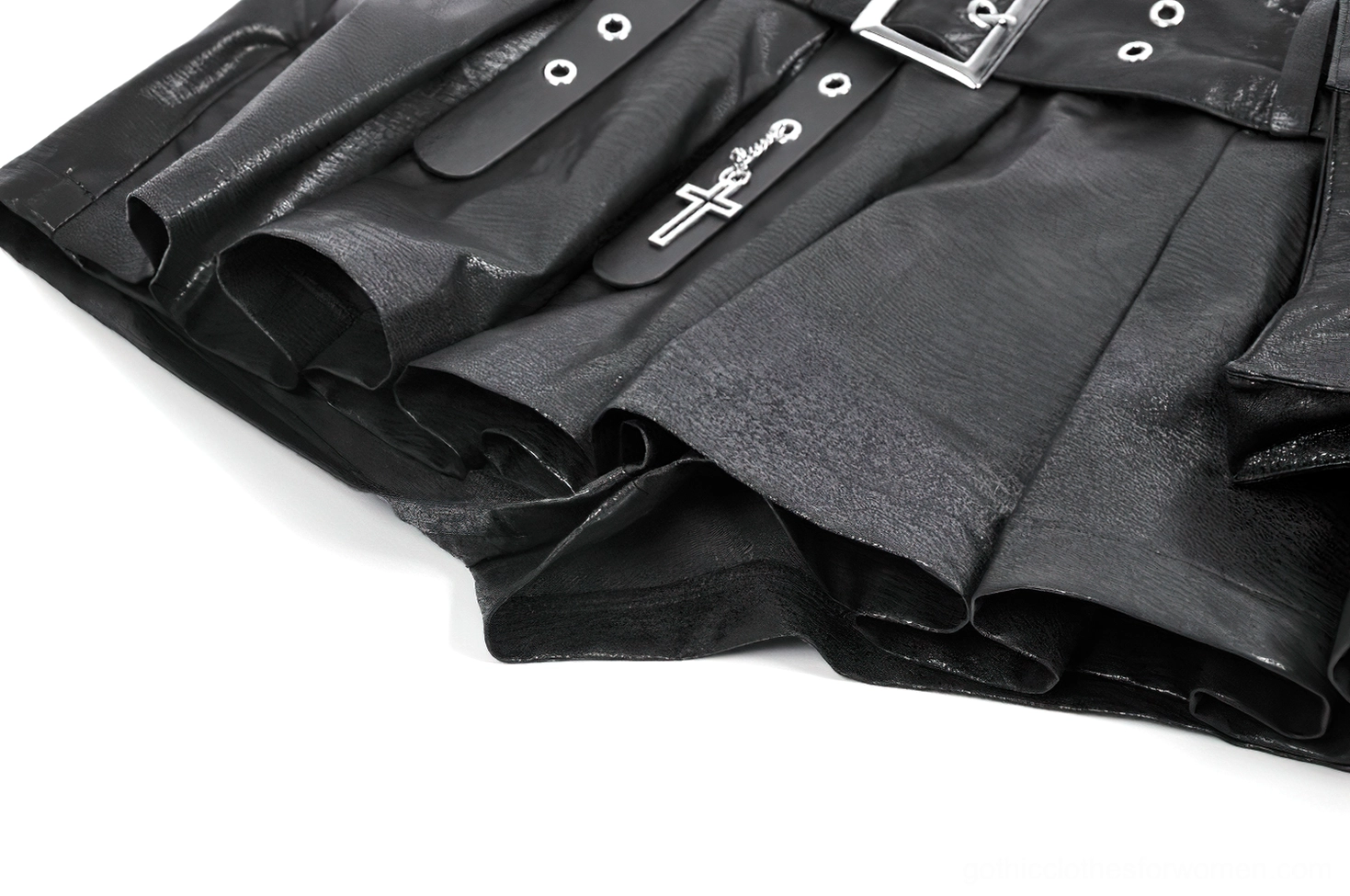 High-resolution detail shot of removable cross charm and industrial metal hardware on black faux leather