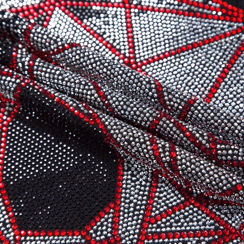 Geometric rhinestone skull applique with silver and red decorative stones close-up view