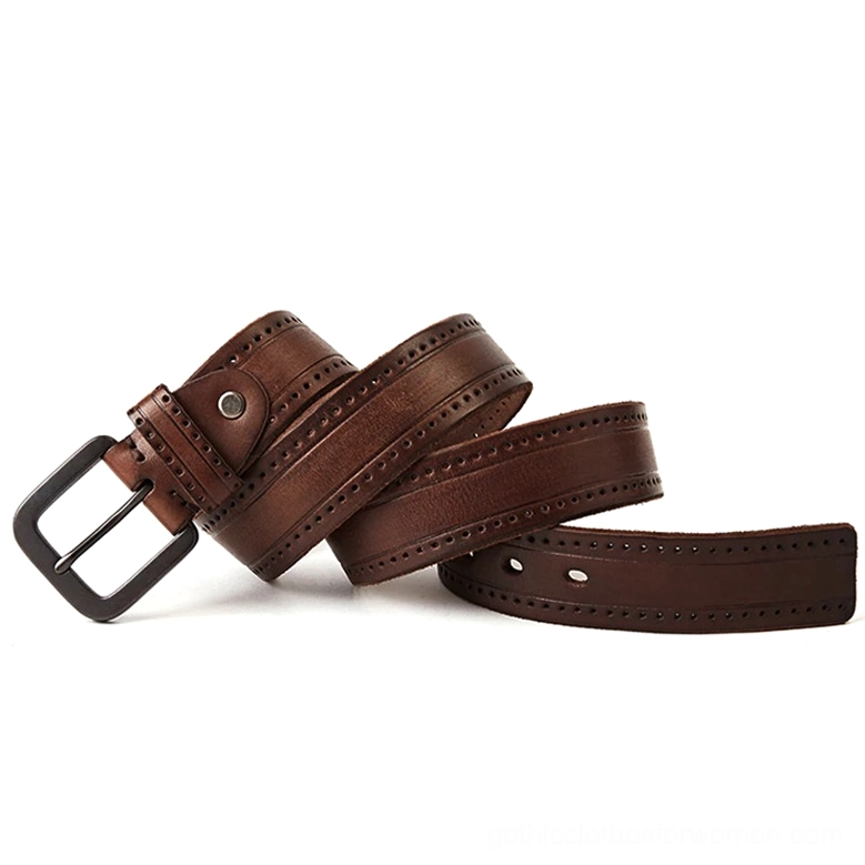 Rolled vintage brown leather belts displaying brogued decorative straps and matte dark metal buckles from angled perspective