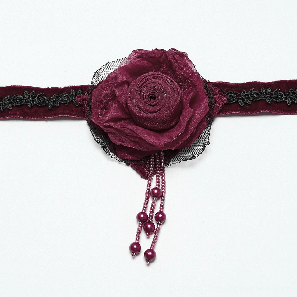 Close-up detail of 3D fabric rose with black lace embroidered backing and burgundy velvet strap