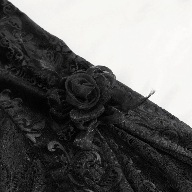 Close-up detail of black rose and feather trim embellishments on damask lace flared gothic pants hem