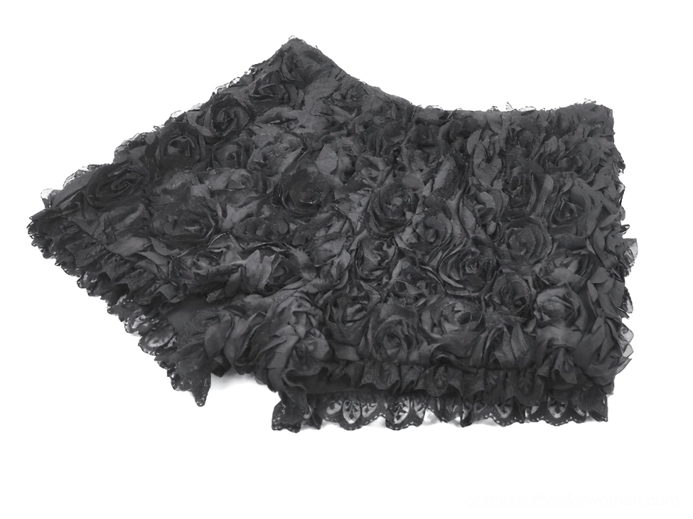 Black rose lace trim gothic shorts low angle flat lay showing 3D appliqué depth and ruffled hem