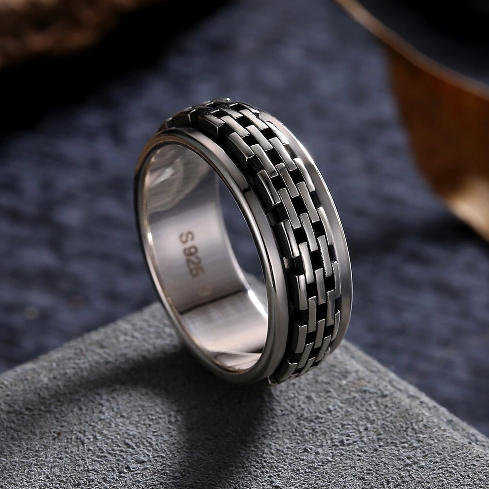 S925 sterling silver gothic chain biker ring close-up displaying hallmark stamp inside band and rotating chain link decoration on dark textured background, authentic certification