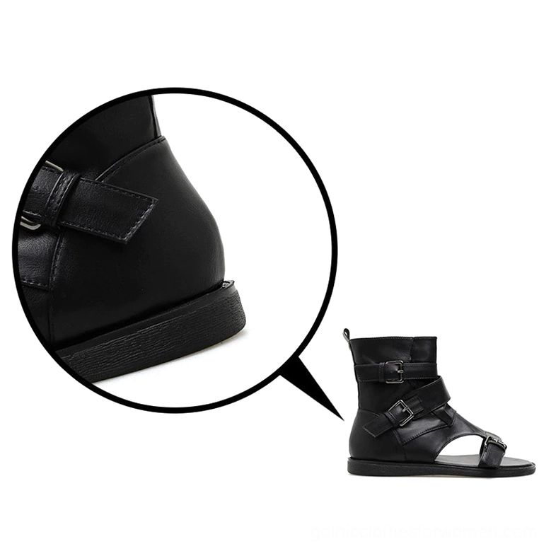 Macro view of black gladiator sandal heel strap with leather buckle fastening and flat sole edge detail