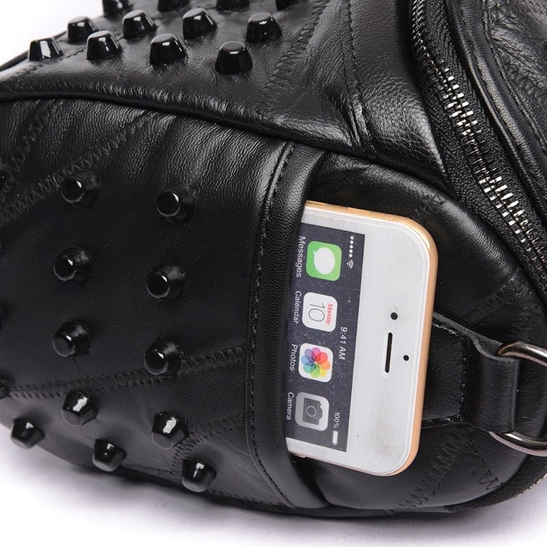 Detailed view of studded sheepskin leather crossbody messenger bag highlighting rivet embellishment and genuine leather craftsmanship