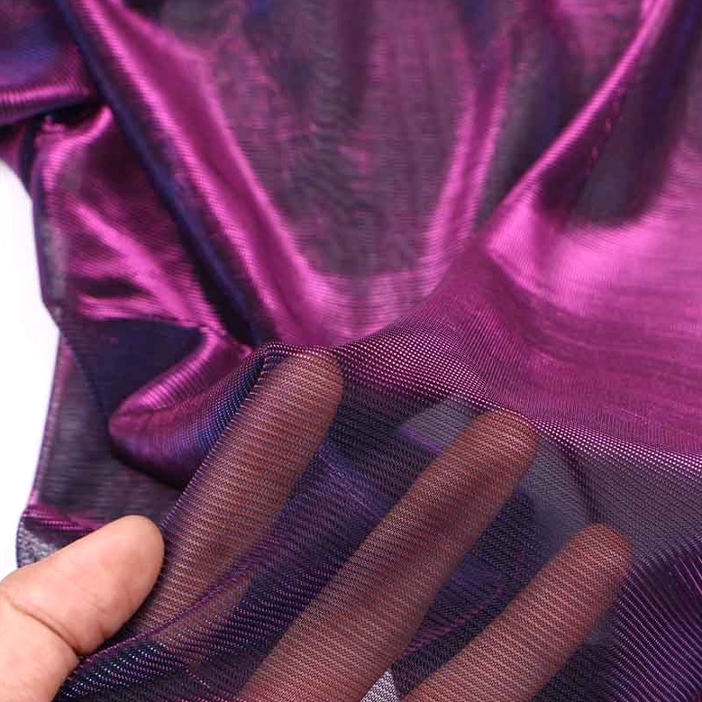 Close-up detail of transparent sheer mesh fabric with iridescent purple sheen, showing texture and weave quality