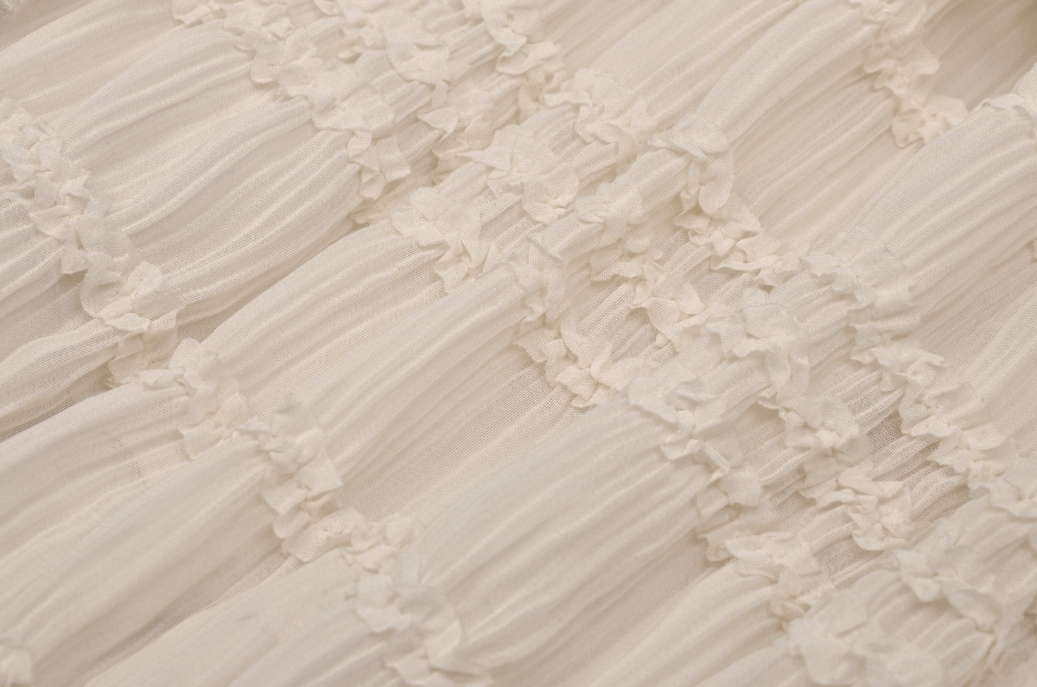 Shirred fabric with ruffled trims close-up detail showing construction quality of the beige lace gothic dress