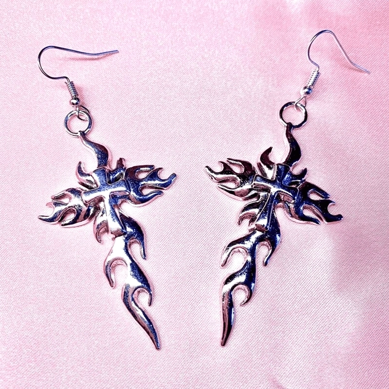 Single silver flaming cross drop earring - detailed view of hollow metal flame cross design for gothic fashion
