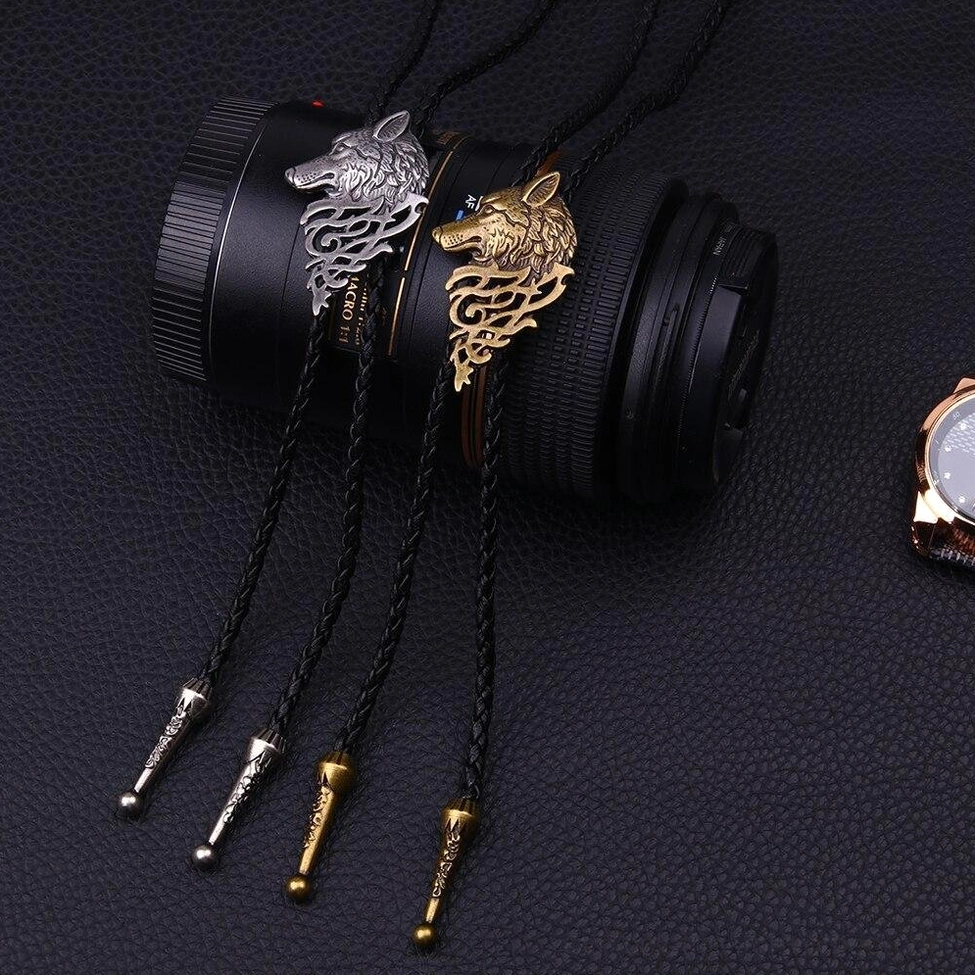 Dual wolf head gothic necklaces flat lay showing silver and gold metal finishes with braided rope chains
