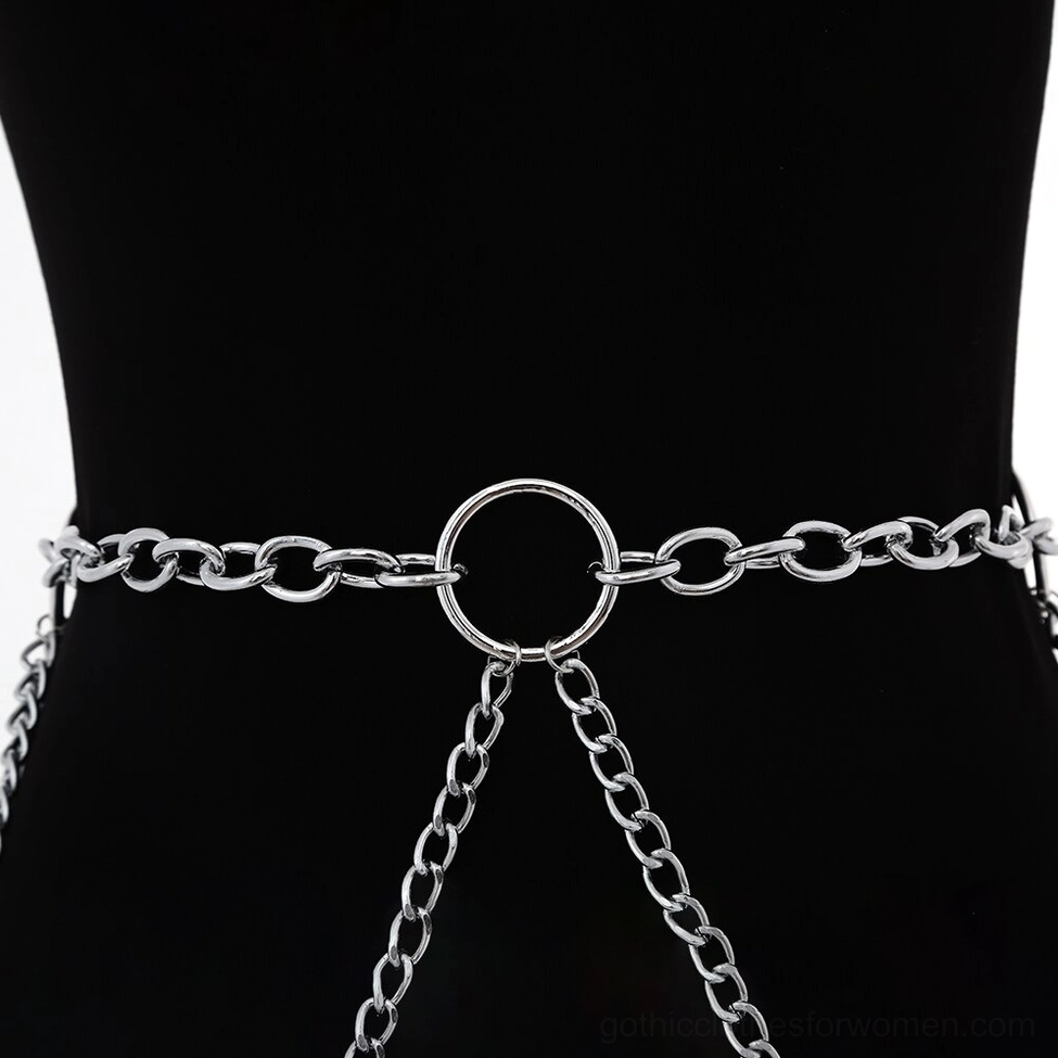 Close-up front view of silver gothic body chain on mannequin, highlighting thick curb chain links, central O-ring anchor, and lower tassel chain elements