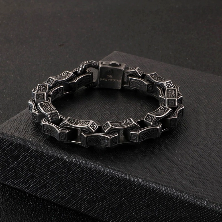 Silver gothic engraved square link bracelet close-up showing link detail and vintage pattern design