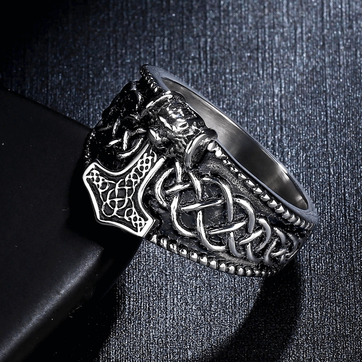 Silver-tone Mjolnir Celtic gothic ring with black engraved Thor's hammer and Celtic knot on textured background