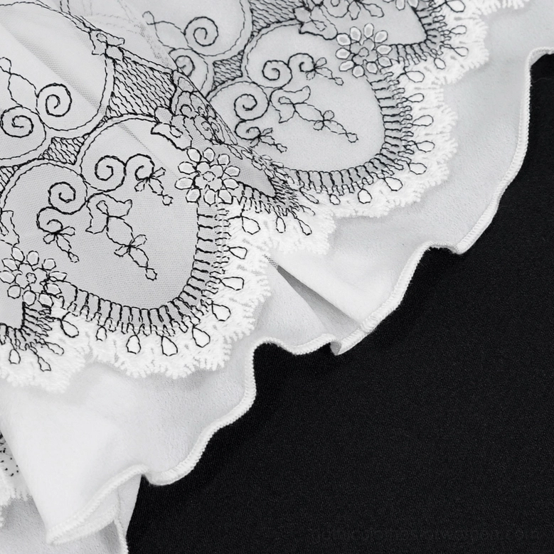 Silver snap fastener close-up on gothic lace glove showing sheer embroidered mesh fabric construction