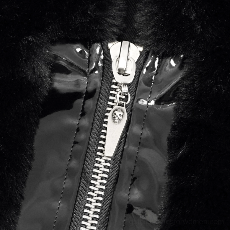 Close-up detail of silver zipper with skull charm on black fuzzy gothic jacket panel