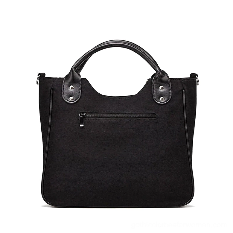 Black canvas gothic tote rear view - exterior zipper pocket and reinforced leather top handles dark academia style