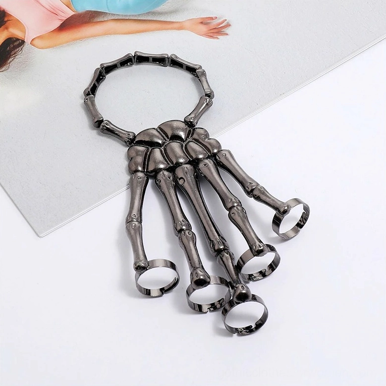 Gunmetal black skeleton hand slave bracelet front flat shot with matte metallic texture and integrated finger rings