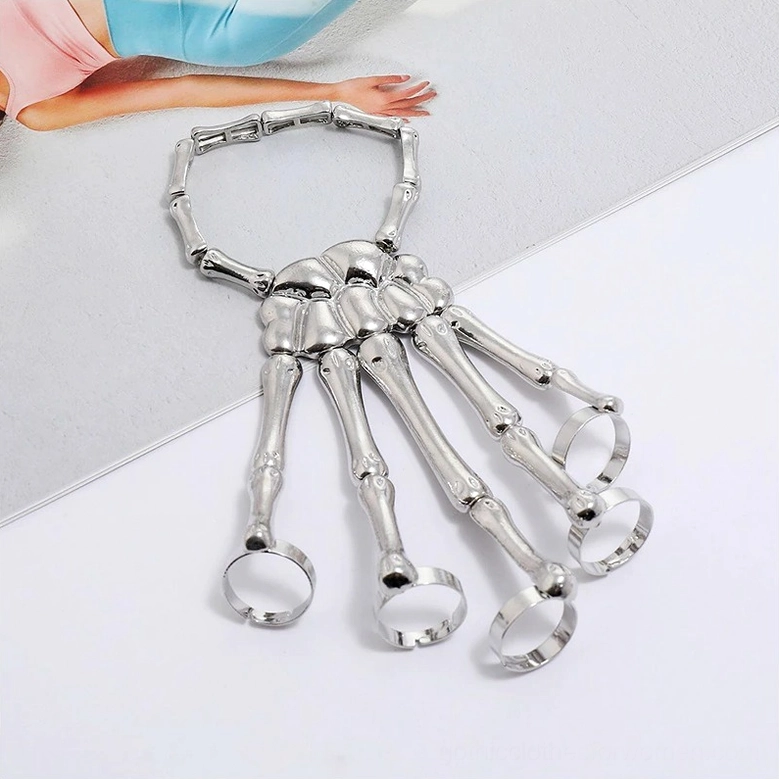 Silver skeleton hand slave bracelet front view showing multiple finger loops and adjustable elastic mechanism