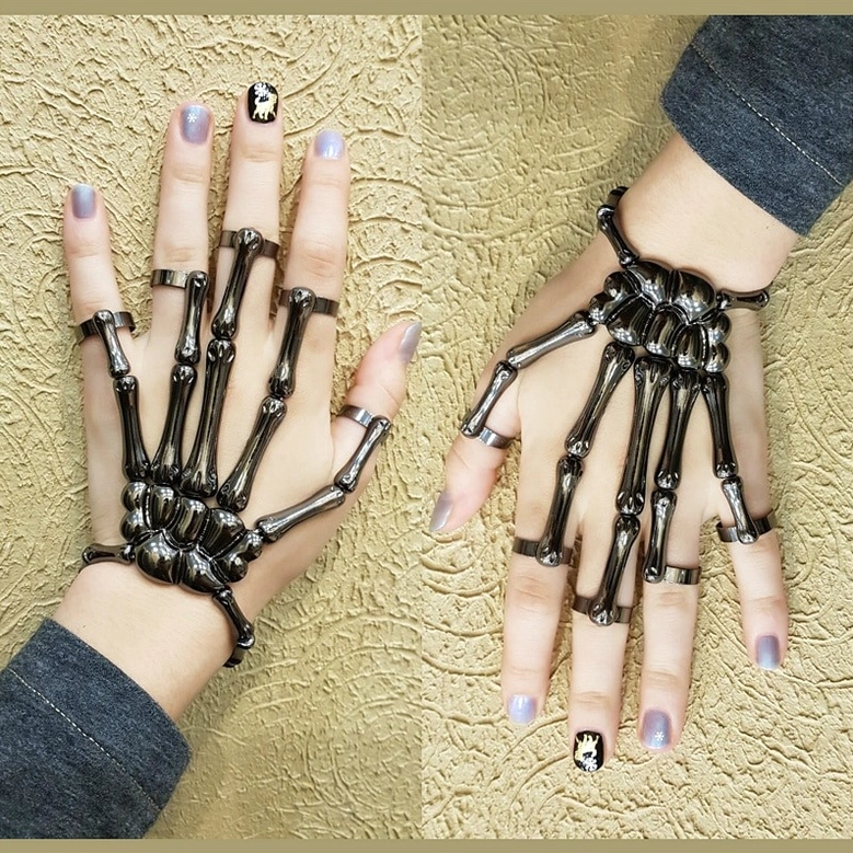 Silver skeleton hand slave bracelet product view highlighting polished finish and finger ring connections