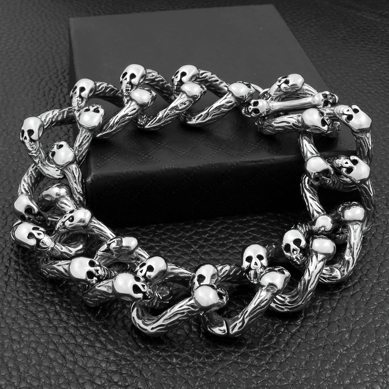 Punk gothic skull chain bracelet displayed on black leather stand showing antique silver curb chain with detailed links