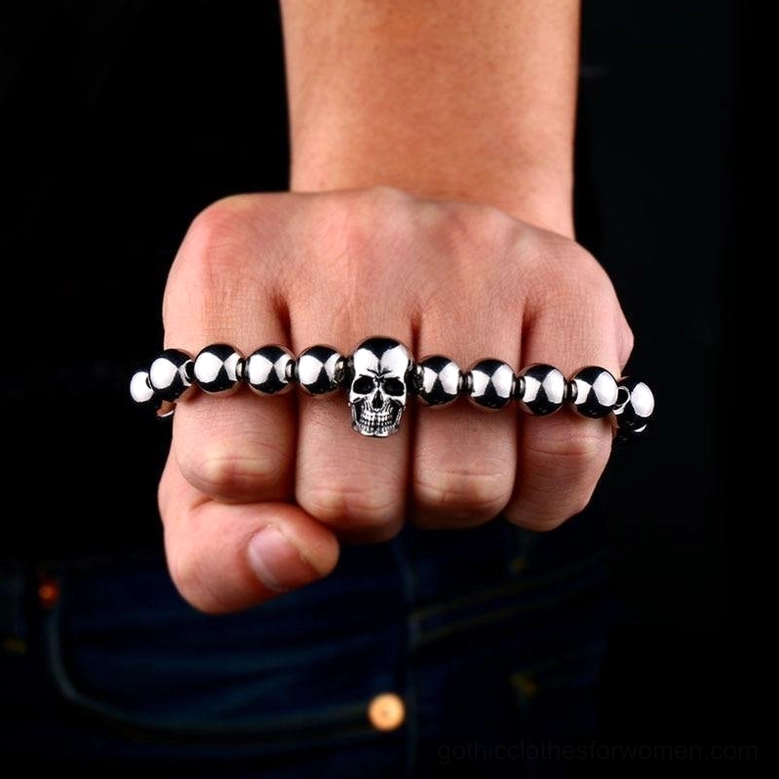 Knuckle duster style skull bracelet fist wear - edgy goth aesthetic layered across knuckles